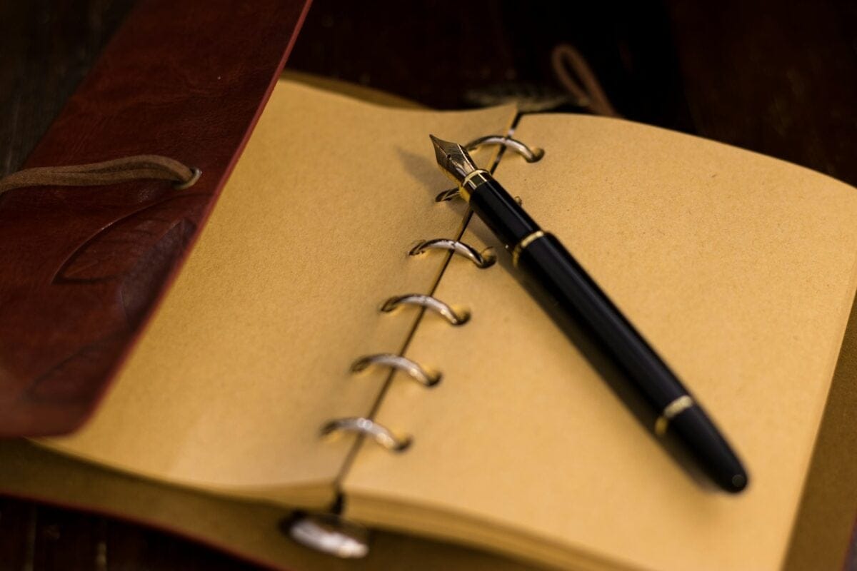 pen sitting on journal paper / iconic pen models