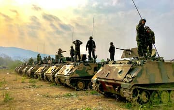 line of tanks and soldiers / wartime military technologies