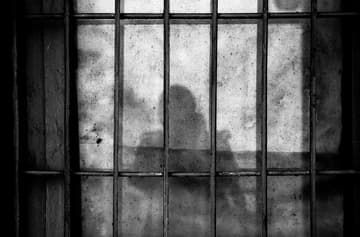 prison bars with human silhouette / haunted civil war prisons