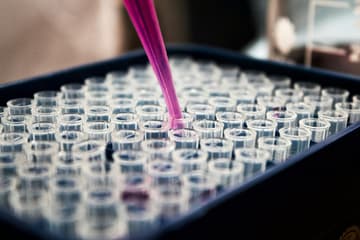 test tubes with purple pipette / cold war military experiments