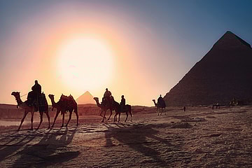 camels walking past pyramids / bizarre egyptian rituals