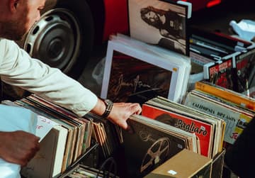 guy looking through vinyl records / collectible vinyl records
