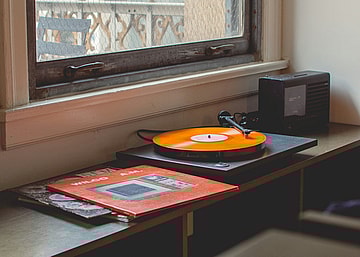 orange record on record player / valuable vinyl records from the 50s