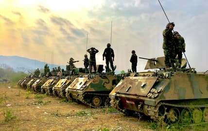 line of tanks and soldiers / wartime military technologies