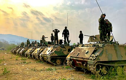 line of tanks and soldiers / wartime military technologies