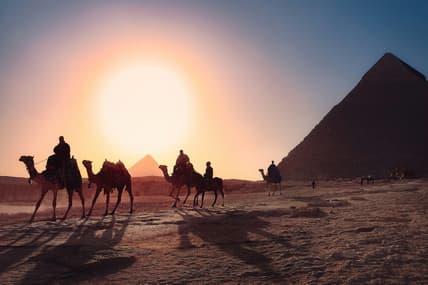 camels walking past pyramids / bizarre egyptian rituals