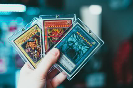 hand holding trading cards