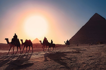 camels walking past pyramids / bizarre egyptian rituals