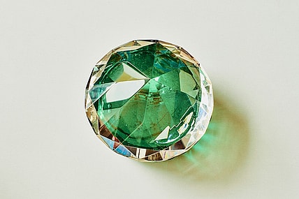 green faux jewel on white background / most famous jewels in history