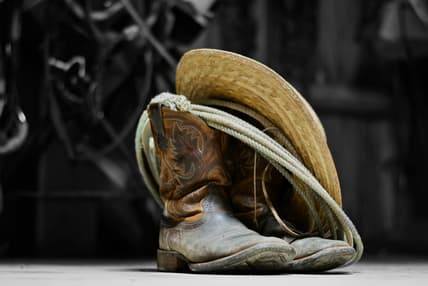 cowboy boots rope and hat / famous outlaws of the wild west