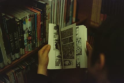 person flipping through comic book / 1940s war comics