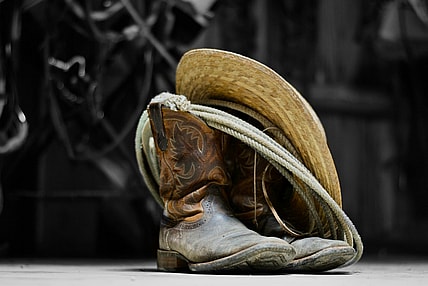 cowboy boots rope and hat / famous outlaws of the wild west