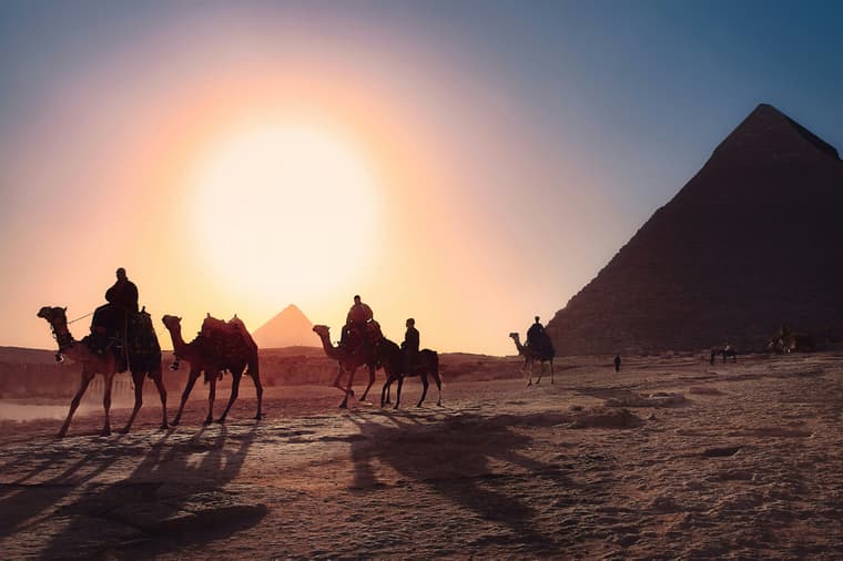 camels walking past pyramids / bizarre egyptian rituals