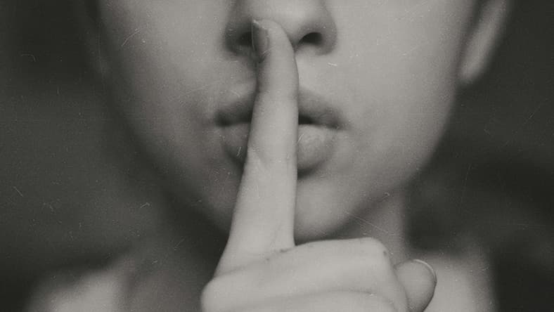 person shhing / secret societies