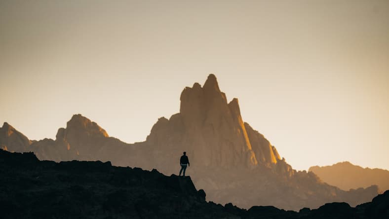 man exploring rock mountains / bizarre explorer stories