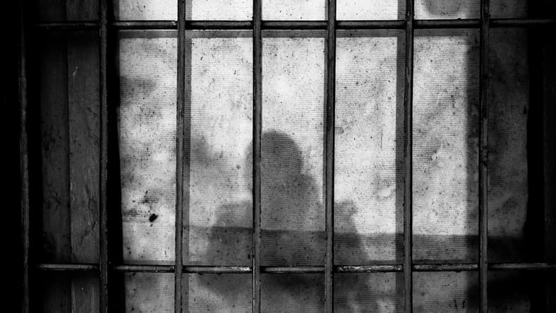 prison bars with human silhouette / haunted civil war prisons
