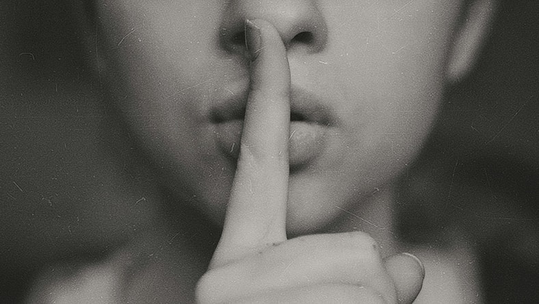person shhing / secret societies