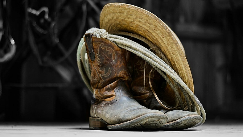 cowboy boots rope and hat / famous outlaws of the wild west