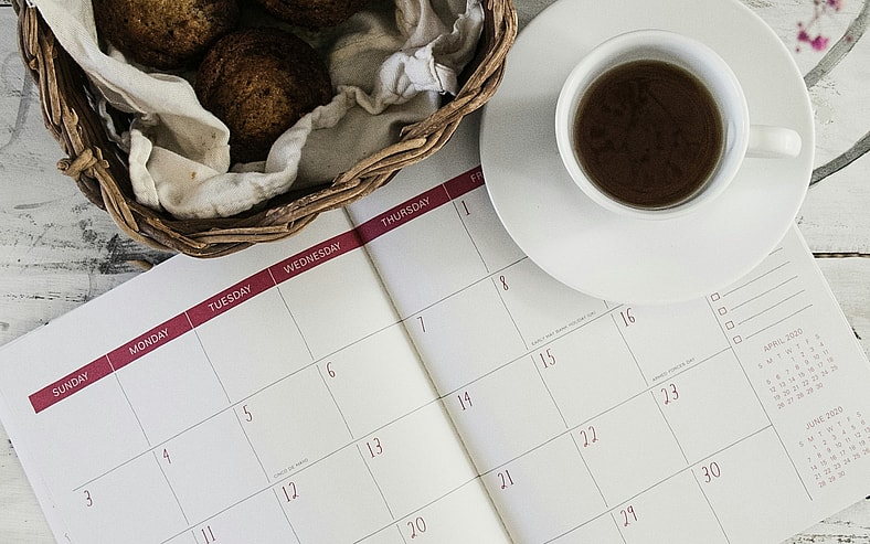 open calendar with coffee cup