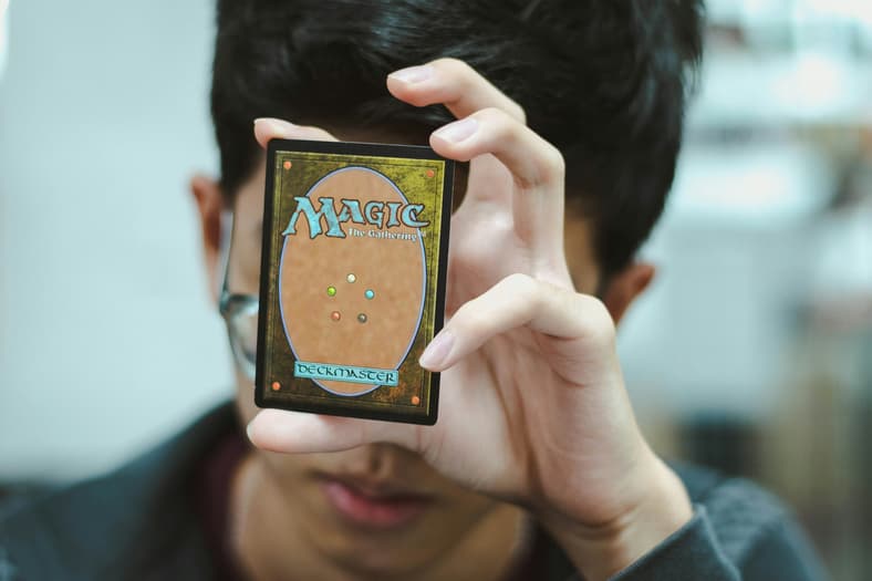 boy holding magic the gathering card