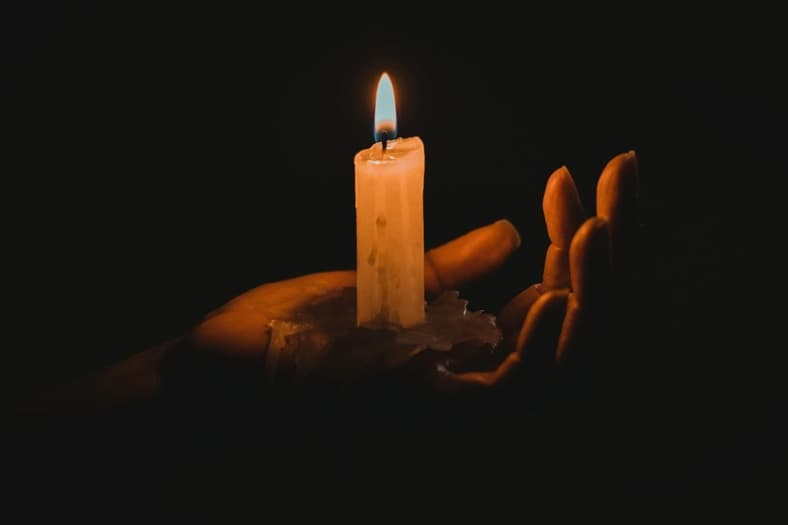 A person holding a candle.