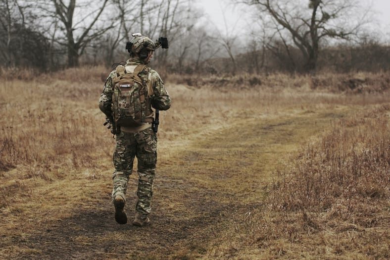 soldier walking in brush