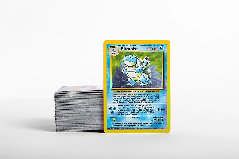 blastoise pokemon card next to stack