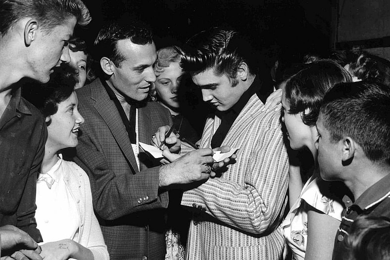 Elvis Presley signing autographs