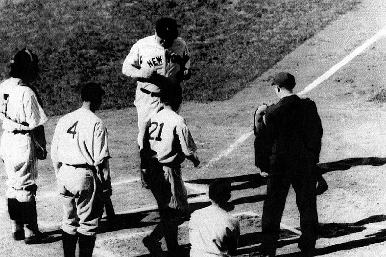 Babe Ruth crosses home plate.