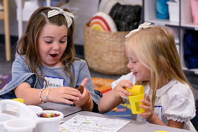 Kindergartners Naomi Coburn, left, and Ivy Sola explore Play-Doh on Wednesday, August 9, 2023 as Central Valley Christian students return to classrooms for the 2023-24 school year.