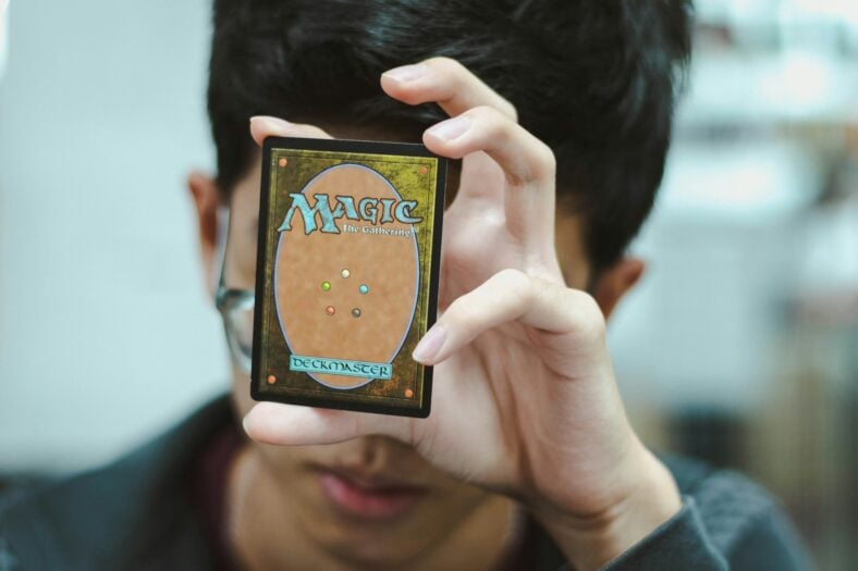 boy holding magic the gathering card