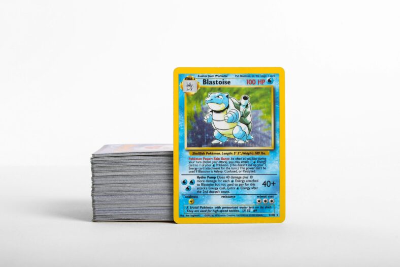 blastoise pokemon card next to stack